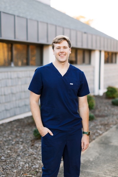 Dr H Outside Bldg Dr. Hanigofsky is standing in black scrubs outside of the office